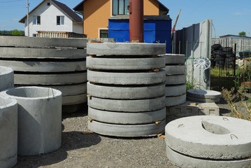 row of gray industrial concrete rings and slabs in the street