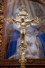 Fototapeta na wymiar Jesus Christ nailed to a golden metal cross
