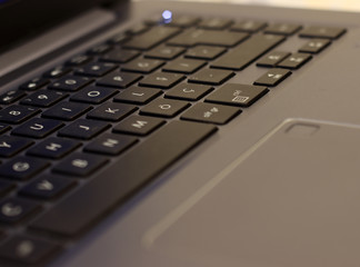 Close up of man hands typing on a laptop computer keyboard.Macro view of man hand working on laptop computer. Closeup male fingers typing buttons on laptop.