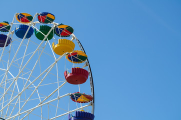 Ferris wheel in the amusement park against the background of the sky. Crimea settlement Mezhvdnoe