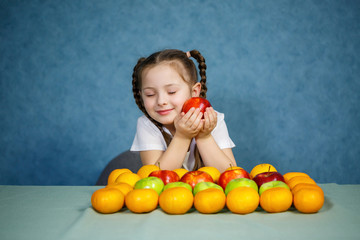 Fototapeta na wymiar Little girl in white T-shirt love fruit