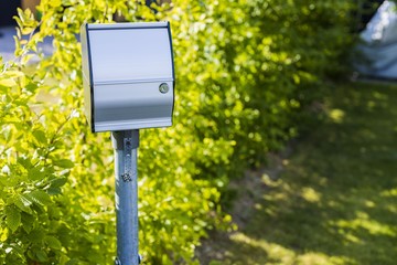 Close up view of outdoor power outlet isolated on green plants background. Technology concept.