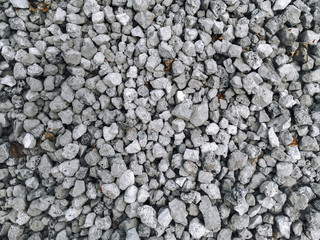 Slag in the form of small gray stones, top view. Waste rock during iron ore mining.