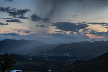 dramatic sunset rain cloud over the caribbean mountains of the dominican republic.