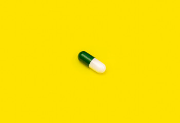 Green pill on yellow background. White pill on orange background. Yellow seamless pattern and green pill.