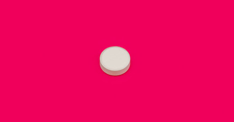 White pill on pink background. Bright pill on red background. Pink seamless pattern and white pill.