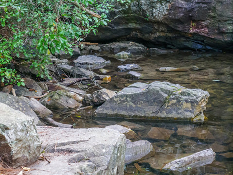 fallen rocks in water along high falls trail in the talladega national forest, alabama, usa