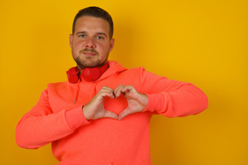 Beautiful caucasian man over isolated background smiling in love showing heart symbol and shape with hands. Romantic concept.