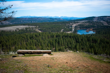 Bench overlooking a valley with a lake