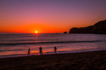 Fototapeta premium Beautiful sunset at the beach in the village of Nazare, Portugal