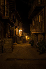 Streets of the village of Mogarraz illuminated at night, Salamanca, Spain