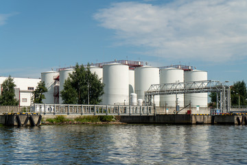 Fototapeta premium industrial fuel tanks in the seaport, large white Industrial tanks for petrol and oil