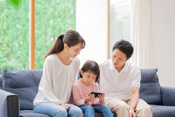 携帯を見る家族　団らん　ポートレート