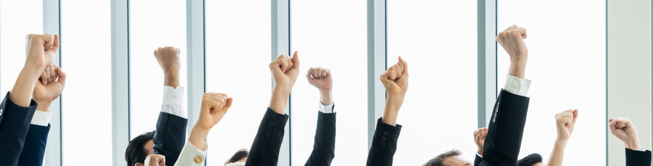 Successful business people standing together showing strong relationship of worker community. A...