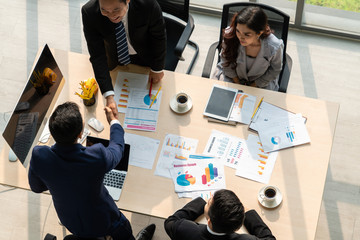 Group business people handshake at meeting table in office together with confident shot from top...