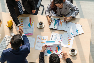 Group business people handshake at meeting table in office together with confident shot from top...