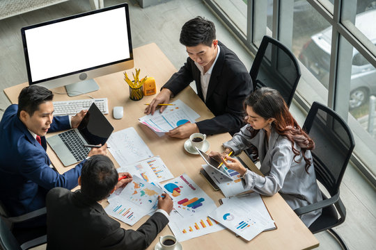 Business people group meeting shot from top view in office . Profession businesswomen, businessmen and office workers working in team conference with project planning document on meeting table .