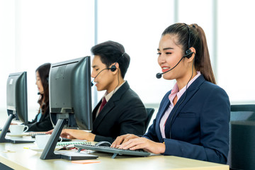 Business people wearing headset working in office to support remote customer or colleague. Call...