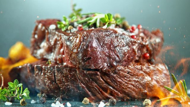Close-up of falling tasty beef steak, super slow motion, filmed on high speed cinematic camera at 1000 fps.