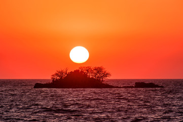 The fantastic sunset island and orange color sky.