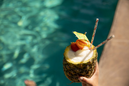 Pineapple cocktail by a pool