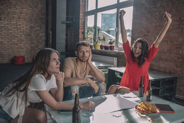 Excited woman enjoying winning in a board game