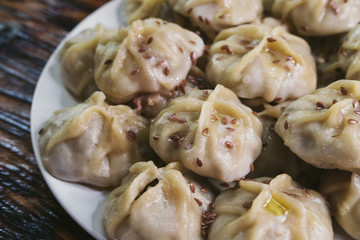 Buuz national dish of dough and meat in a plate on wooden table