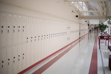Empty school hallway lined with lockers
