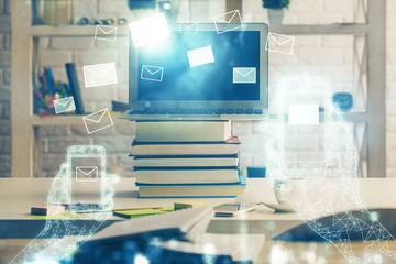 Desktop computer background in office and flying envelops hologram drawing. Double exposure. Electronic mail concept.