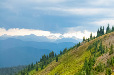 a grassy hill and a cloudy sky view before the rain