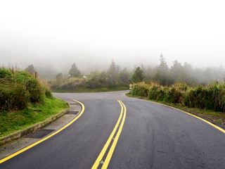 Road in mountain range in fog,Taipei