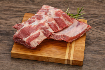 Raw pork ribs served rosemary