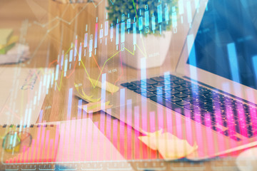 Multi exposure of graph and financial info and work space with computer background. Concept of...