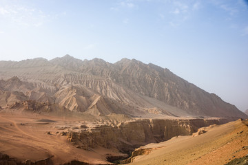 Fototapeta na wymiar Flaming Mountains or Gaochang Mountains are barren, eroded, red sandstone hills near Turpan, Xinjiang, China