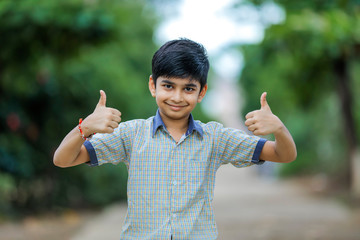 indian school boy showing thumb up