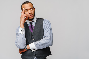 African-American businessmanman making hard decision over grey background