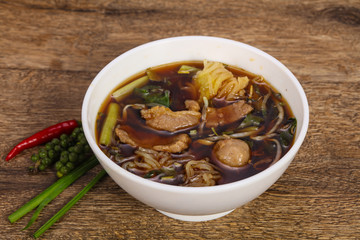 Thai style soup with meat and mushrooms