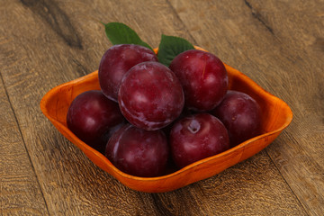 Plum heap in the wooden basket