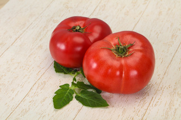 Ripe tomato over wooden background