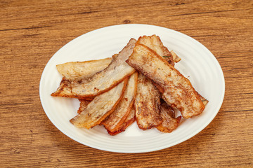 Roasted juicy bacon in the plate