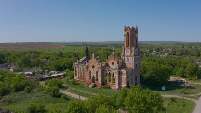 Church of St. Mary in the neo-gothic style in the village of Kamenka, Saratov region, Russia. The ruins of the church wall. Aero 4K