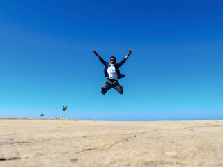 Concept of success and achievement.. Man jamp on sky. Jamping man with blue sky background. Bandarban, Bangladesh / 2018.