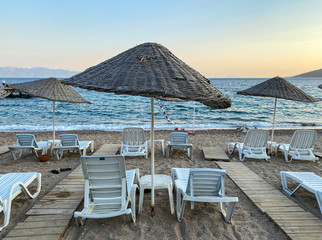empty beach and sunbeds in the evening
