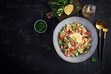 Tabbouleh salad. Traditional middle eastern or arab dish. Levantine vegetarian salad with parsley, mint, bulgur, tomato. Top view