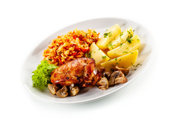 Fried chicken breast with boiled potatoes and vegetables on white background
