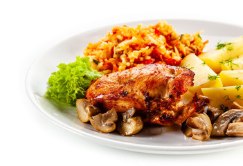 Fried chicken breast with boiled potatoes and vegetables on white background
