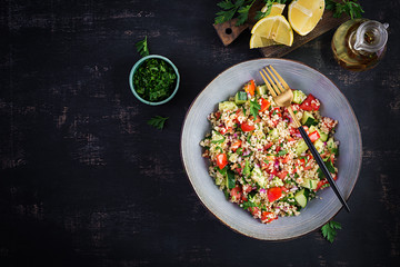 Tabbouleh salad. Traditional middle eastern or arab dish. Levantine vegetarian salad with parsley, mint, bulgur, tomato. Top view