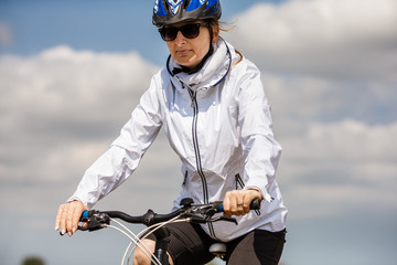 Urban biking - woman riding bike in city park