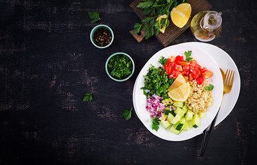 Tabbouleh salad. Traditional middle eastern or arab dish. Levantine vegetarian salad with parsley, mint, bulgur, tomato. Top view