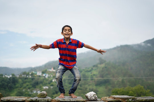 Little Indian Kid Jumping With Joy On The Roof